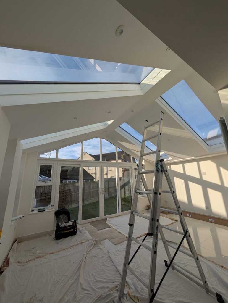 Reclaimed timber feature wall and exposed beams in a finished garden room